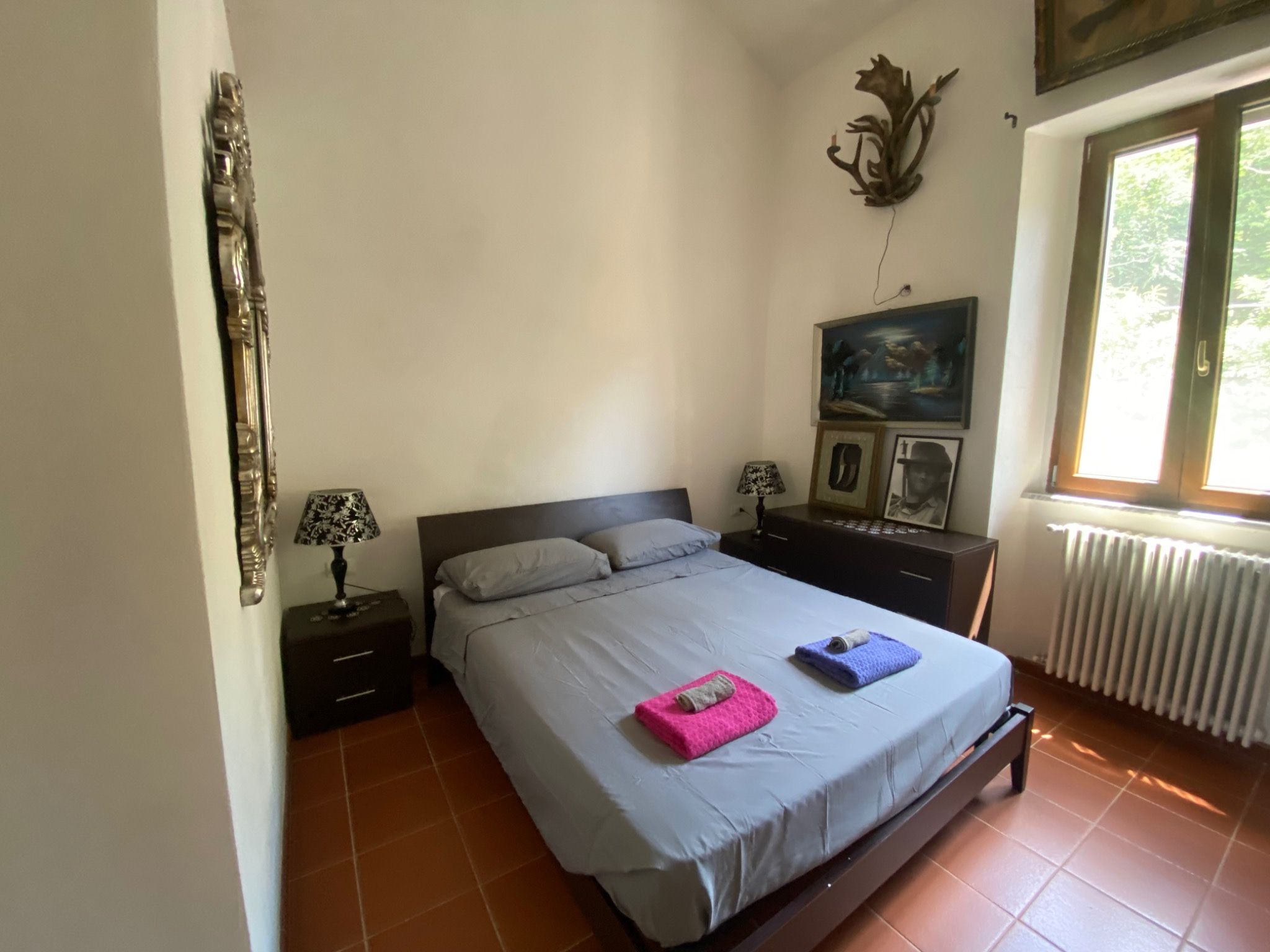 Bright double bedroom with terracotta flooring