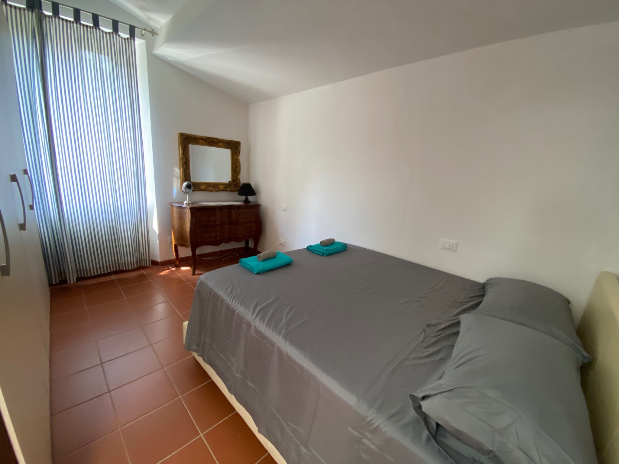 Furnished double bedroom with terracotta flooring