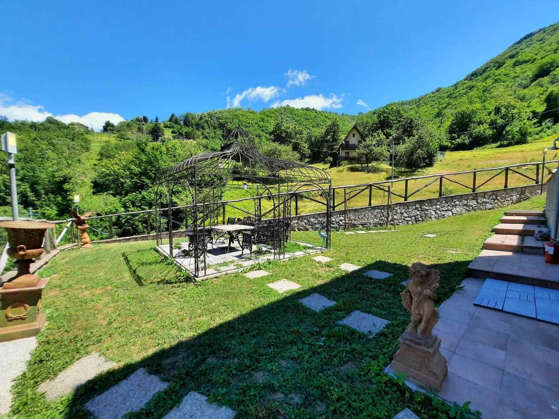 Private garden at Cava House with gazebo and green hillsides