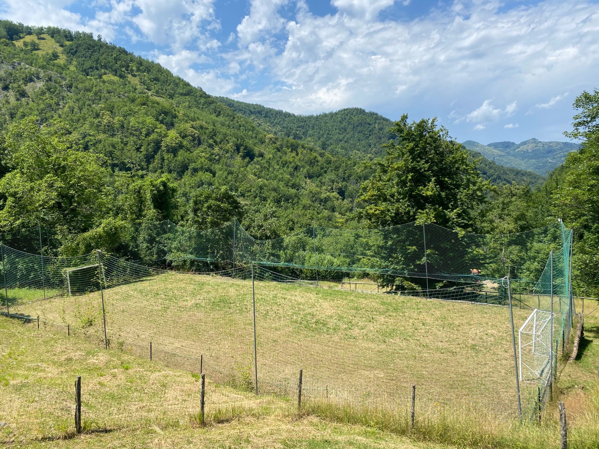 Private five-a-side football pitch surrounded by mountains