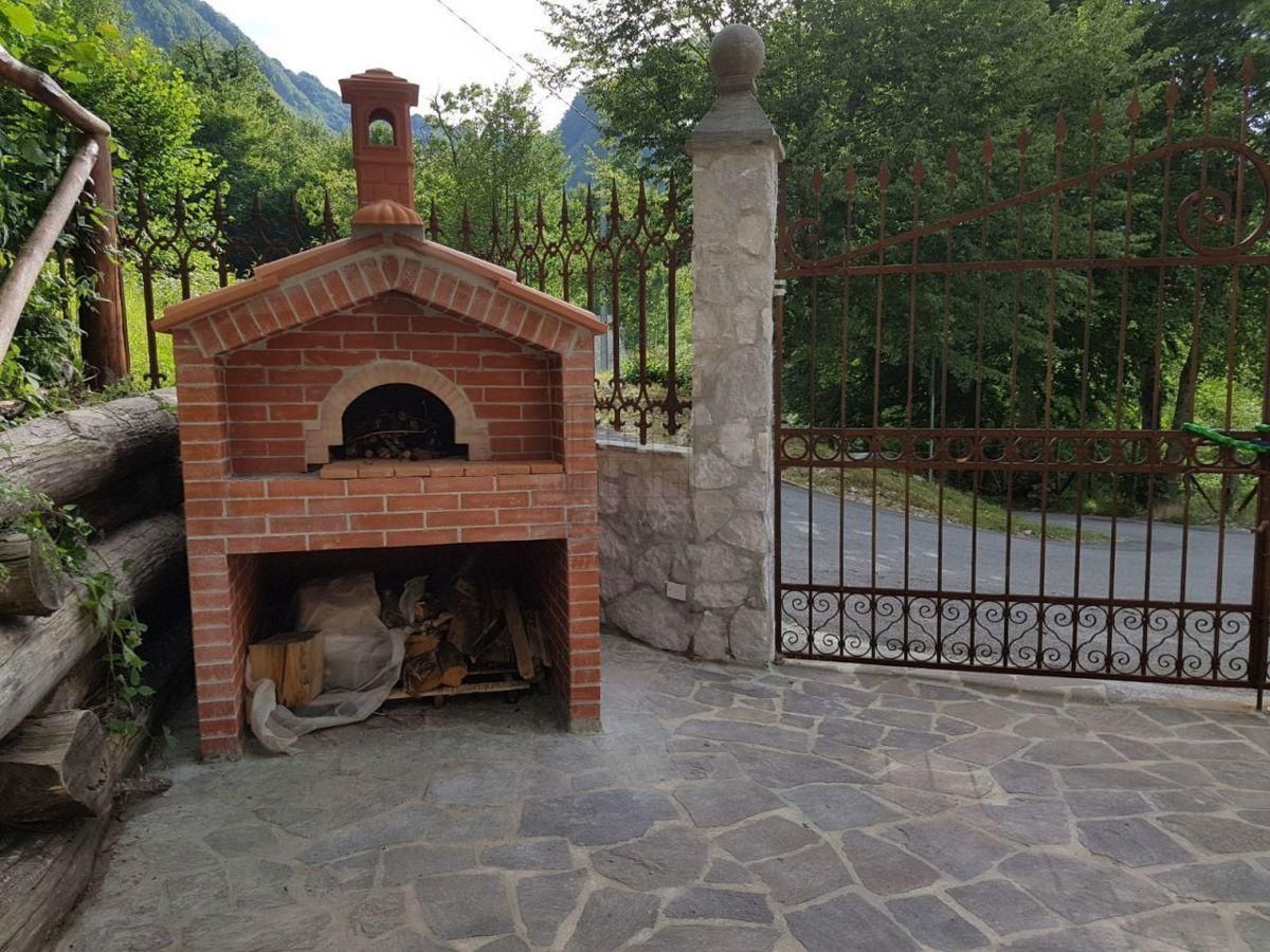 Masonry wood-fired oven beside the gated entrance